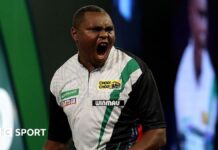 PDC World Darts Championship 2026: David Munyua stuns world number 18 Mike de Decker in first round David Munyua celebrates beating Mike de Decker