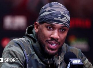 Anthony Joshua: Boxer flies back to UK after fatal crash in Nigeria Anthony Joshua speaking during a news conference before his fight against Jake Paul
