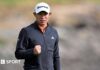 Pebble Beach Pro-Am: Collin Morikawa ends trophy drought Collin Morikawa clenches his right fist after sinking his winning putt. He is wearing a white cap and black zipped-up top.