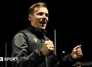 Jordan Hadaway: The 24-year-old manager who has won a top-flight promotion with Llandudno Llandudno manager Jordan Hadaway celebrates with his fists clenched