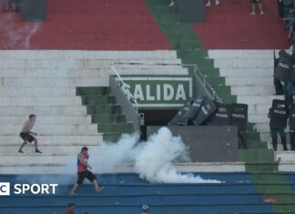 Paraguay derby abandoned as police fire rubber bullets and tear gas amid violent clashes Police fire tear gas in an attempt to quell trouble during a game between Olimpia and Cerro Porteno in the Paraguay captial Asuncion.
