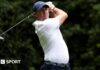 Rory McIlroy cards 70 in first round at Quail Hollow in Truist Championship Rory McIlroy at the Truist Championship, wearing a white golf shirt and blue cap, swinging a metal wood